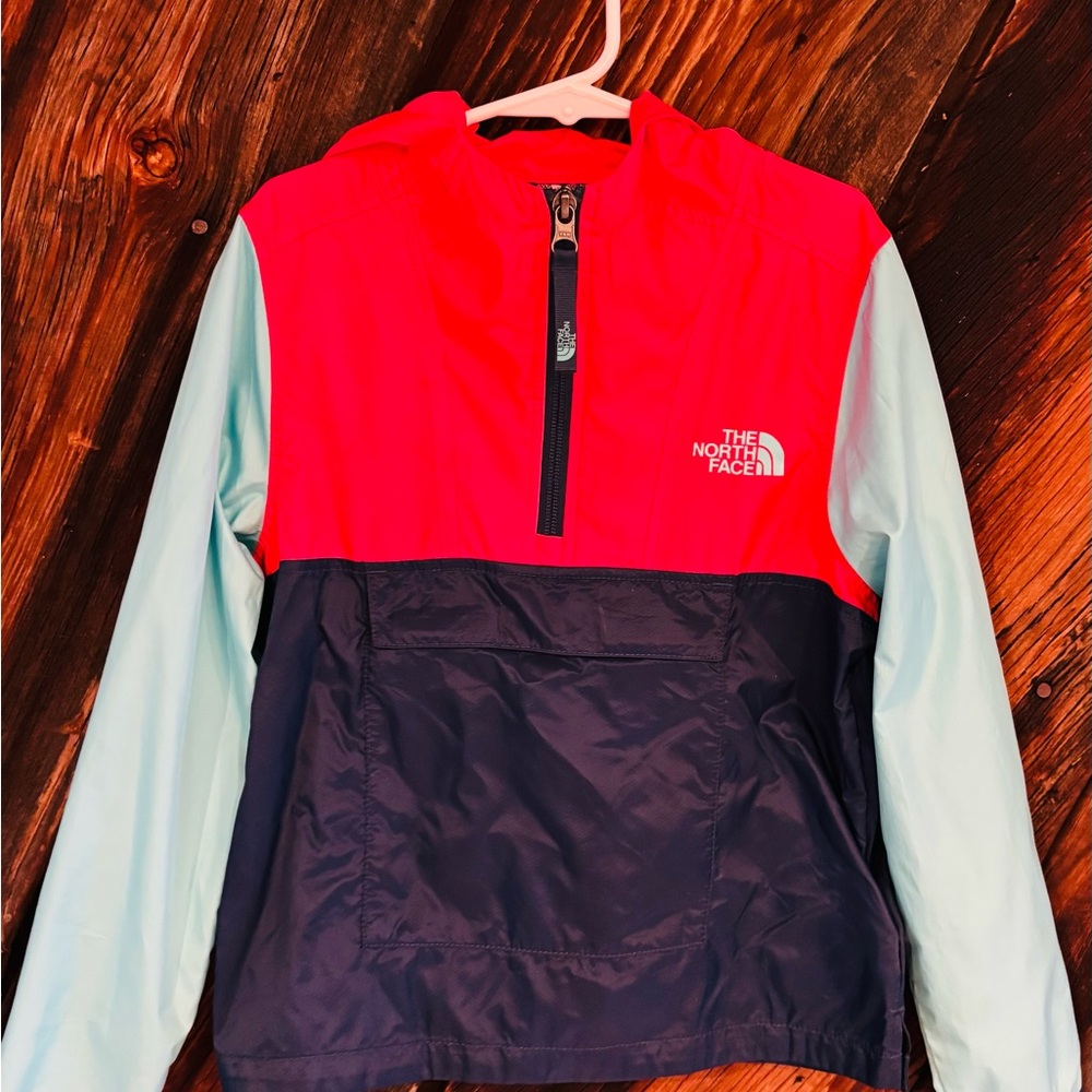 Girl’s The North Face water-resistant jacket. Bright red and navy design.